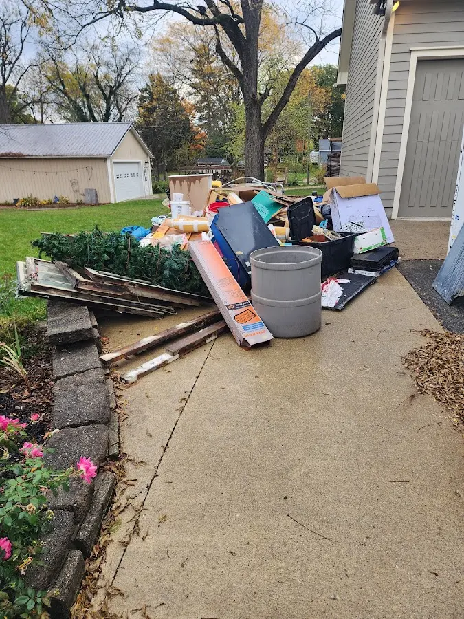 Dumpster being loaded with debris for 10 Yard Dumpster Rental in Winnemucca